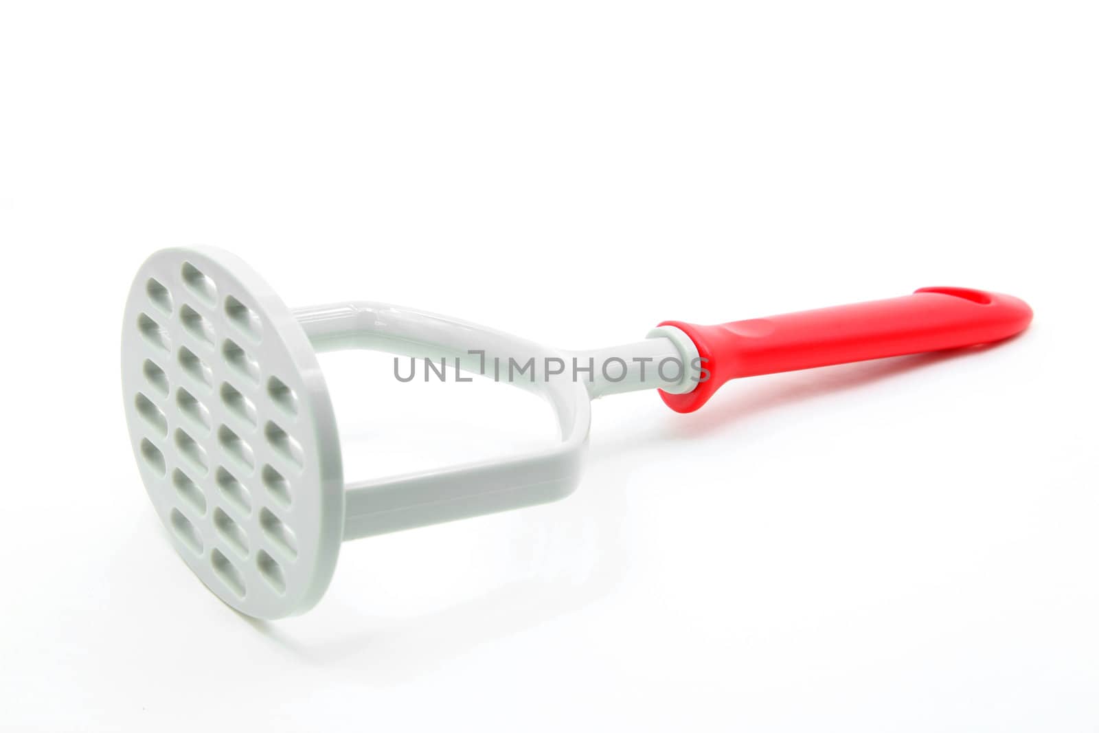studio shot of plastic potato masher isolated on white background