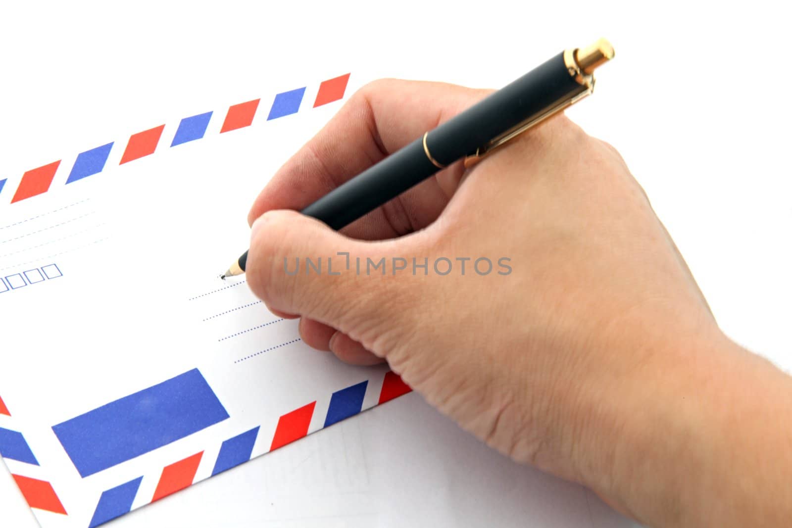 perspective of hand writing address on air mail envelope