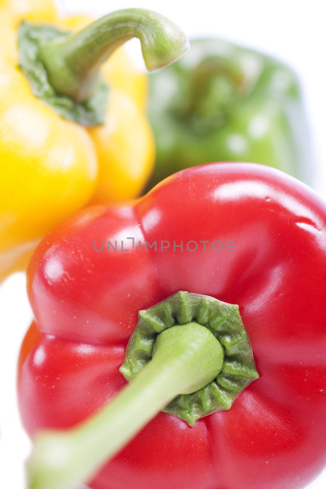 Red Yellow and Green peppers laid out next to each other