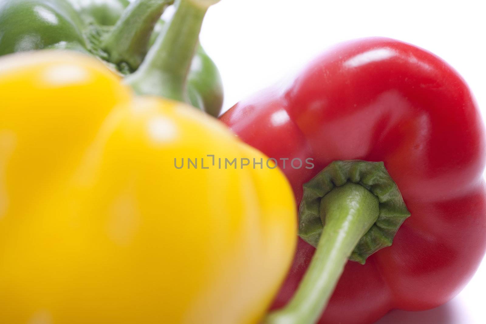 Red Yellow and Green peppers laid out next to each other