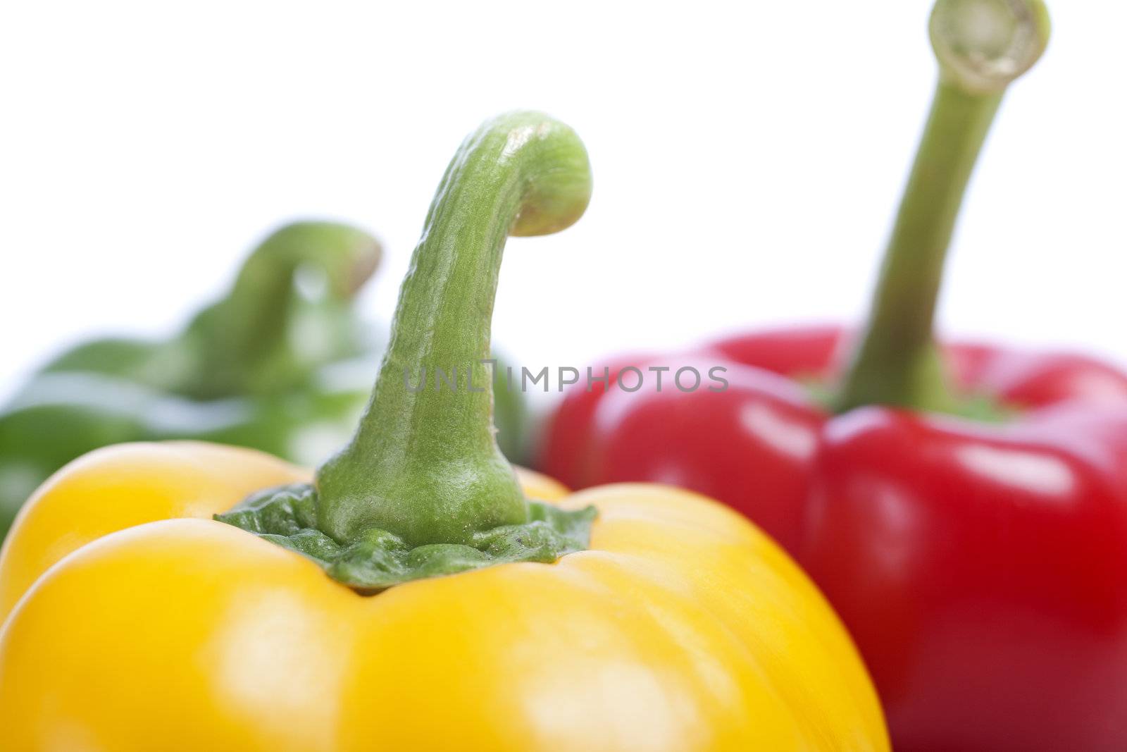 Red Yellow and Green peppers laid out next to each other