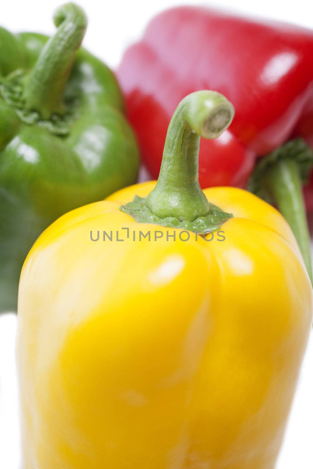 Red Yellow and Green peppers laid out next to each other