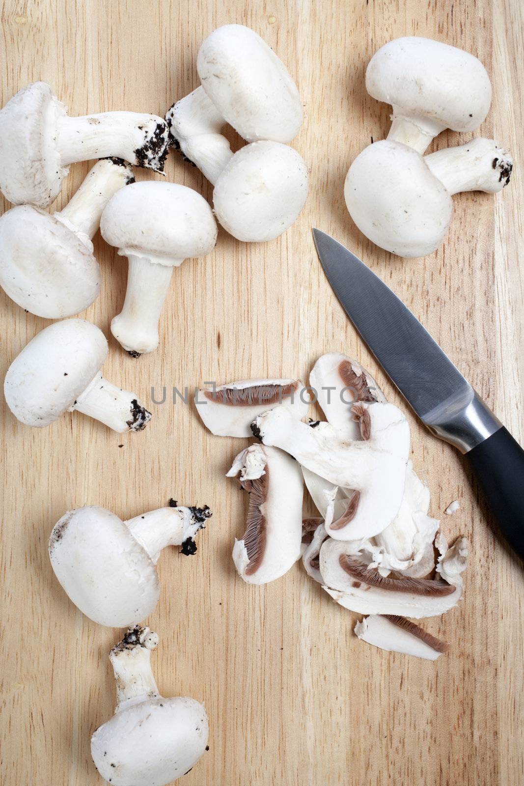 Fresh mushrooms on chopping board by studiofi