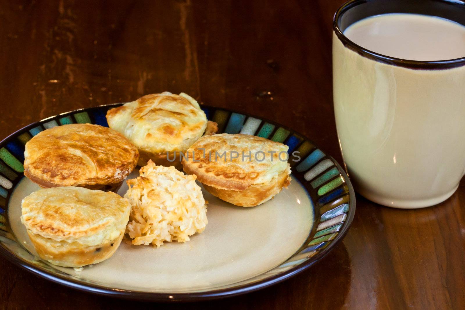 Mini cakes on a plate with a cup o coffee