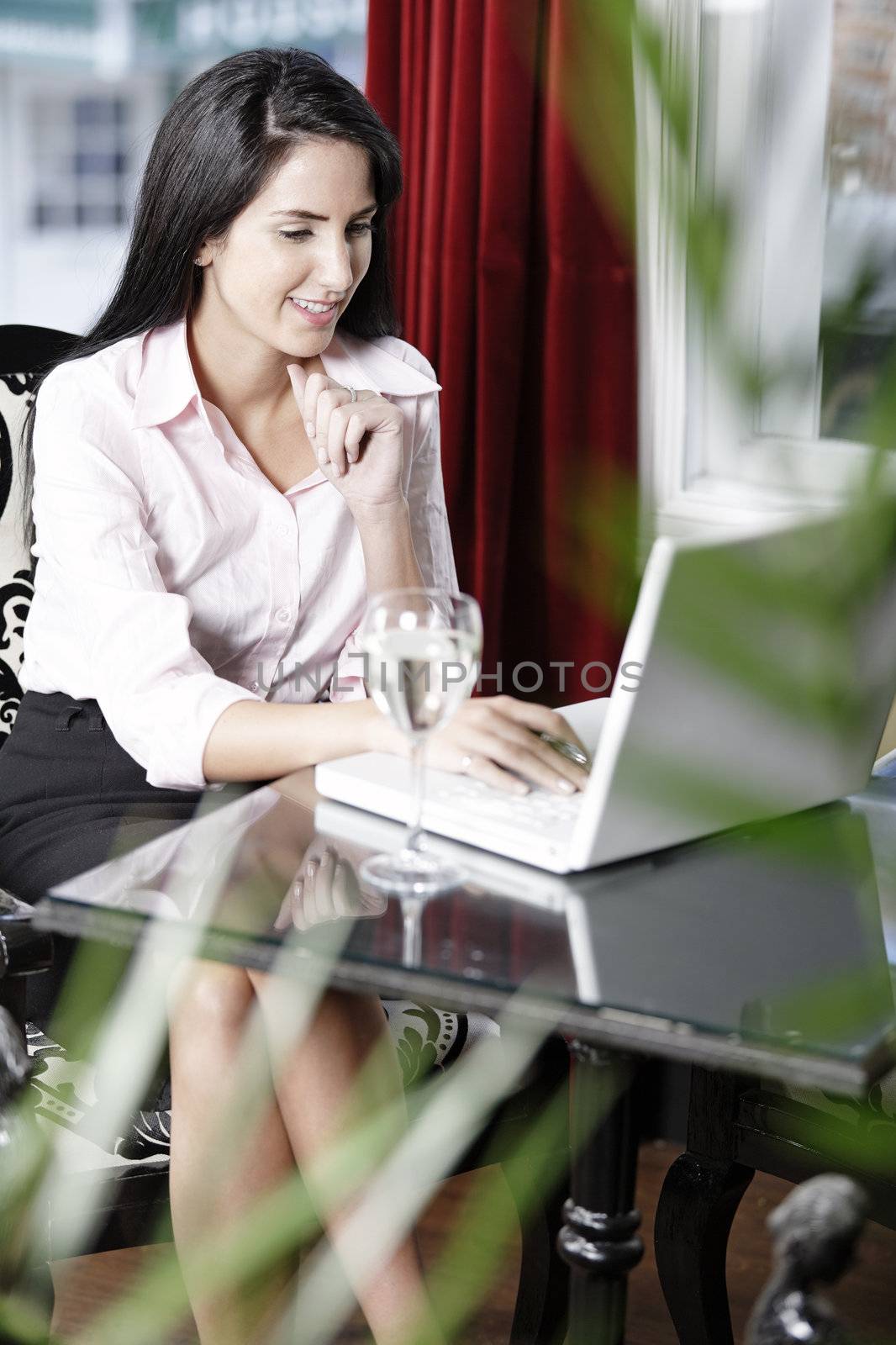 Attractive woman working on her laptop catching up after a long day.