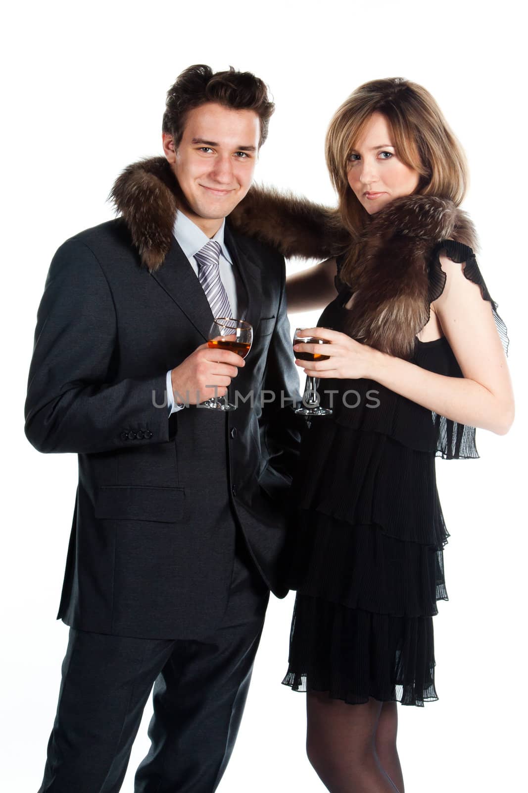 Portrait of a beautiful young couple with glasses of wine and a gift box with a red bow