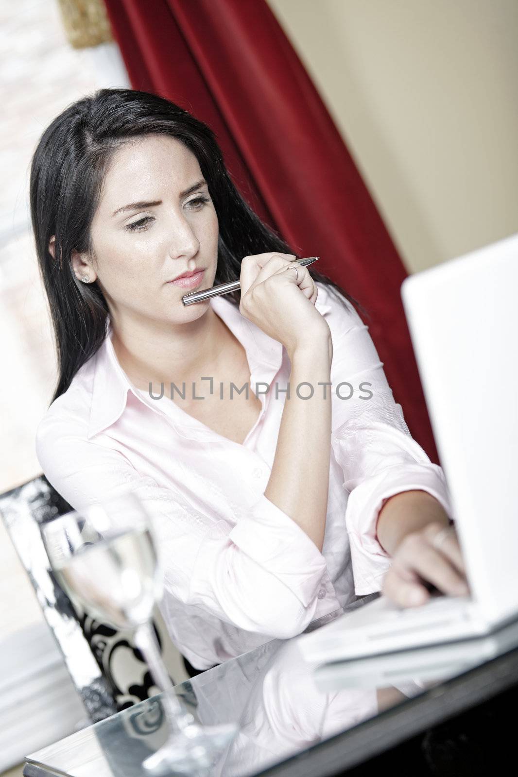 Attractive woman working on her laptop catching up after a long day.