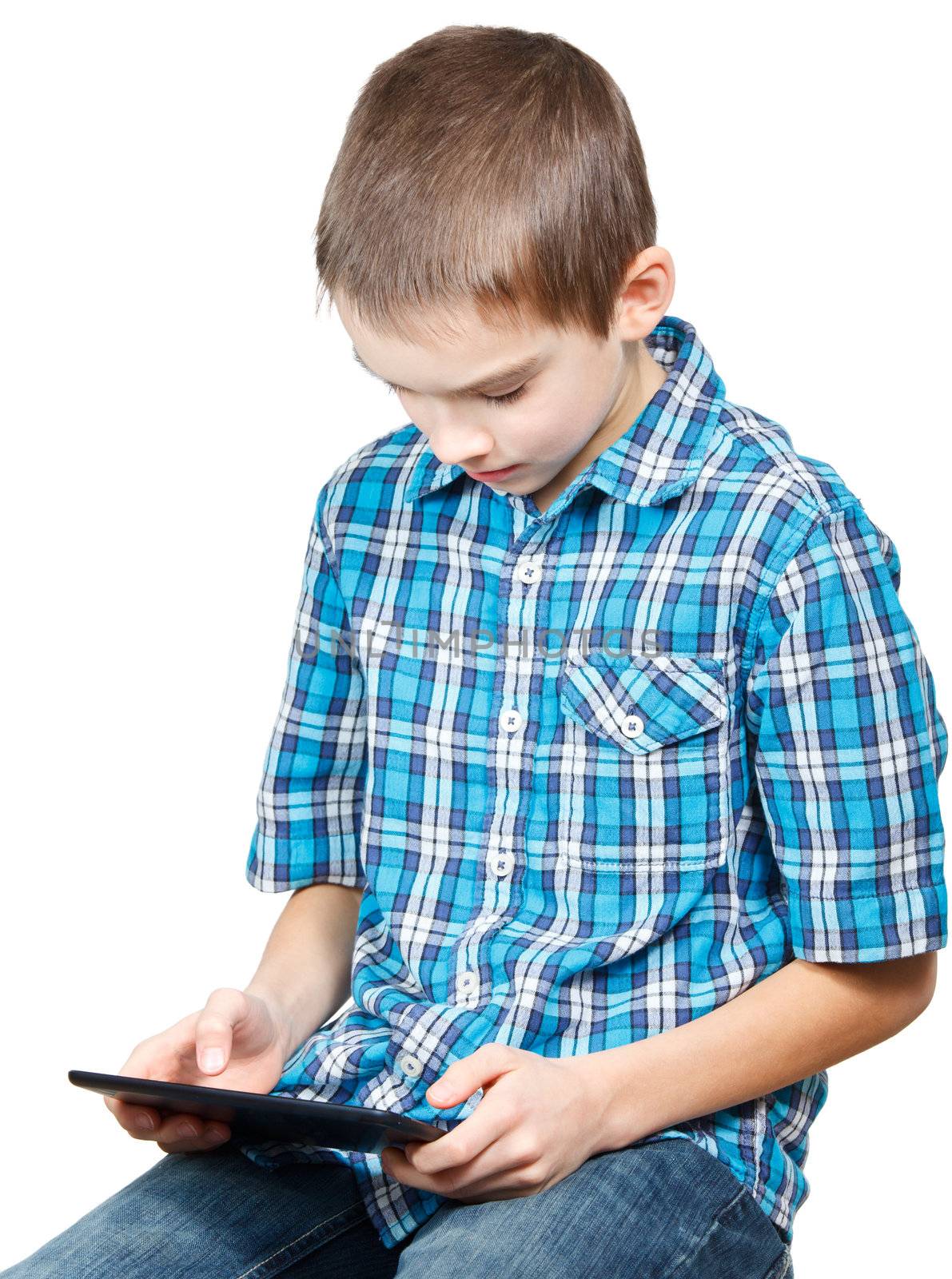 Portrait of 10 years boy wearing blue shirt using a touch pad