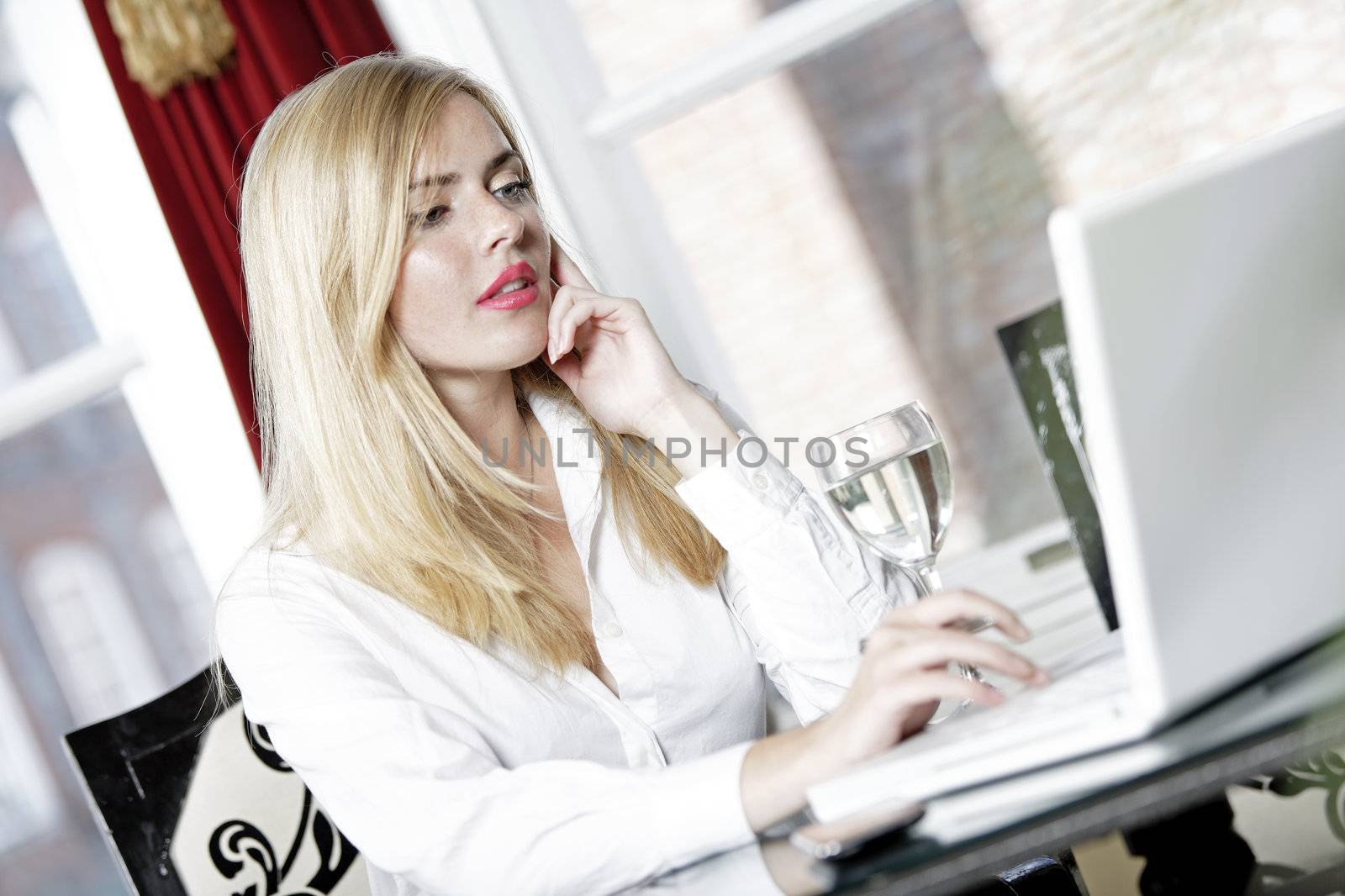 Attractive woman working on her laptop catching up after a long day.