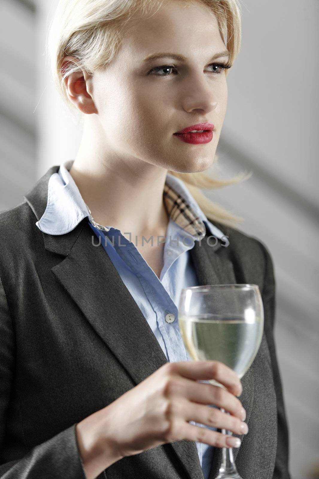 Young woman enjoying a glass of wine after work.