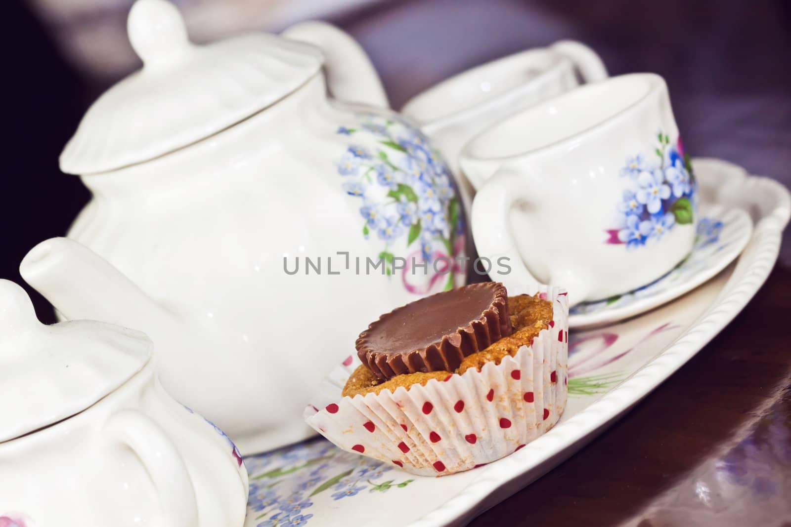 Cupcake with a note tea pot and cup of coffee