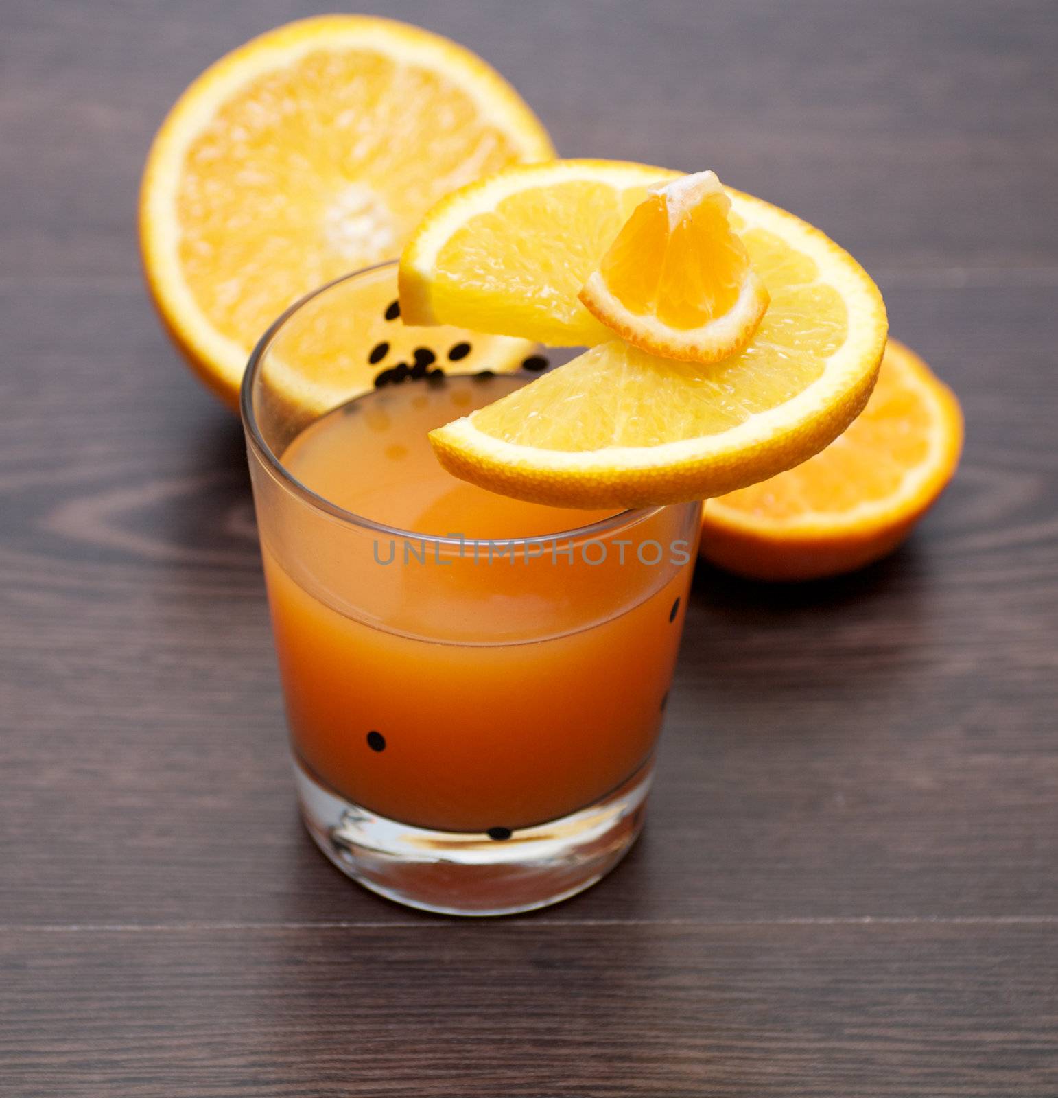 Fresh Orange juice with orange slices on wooden background