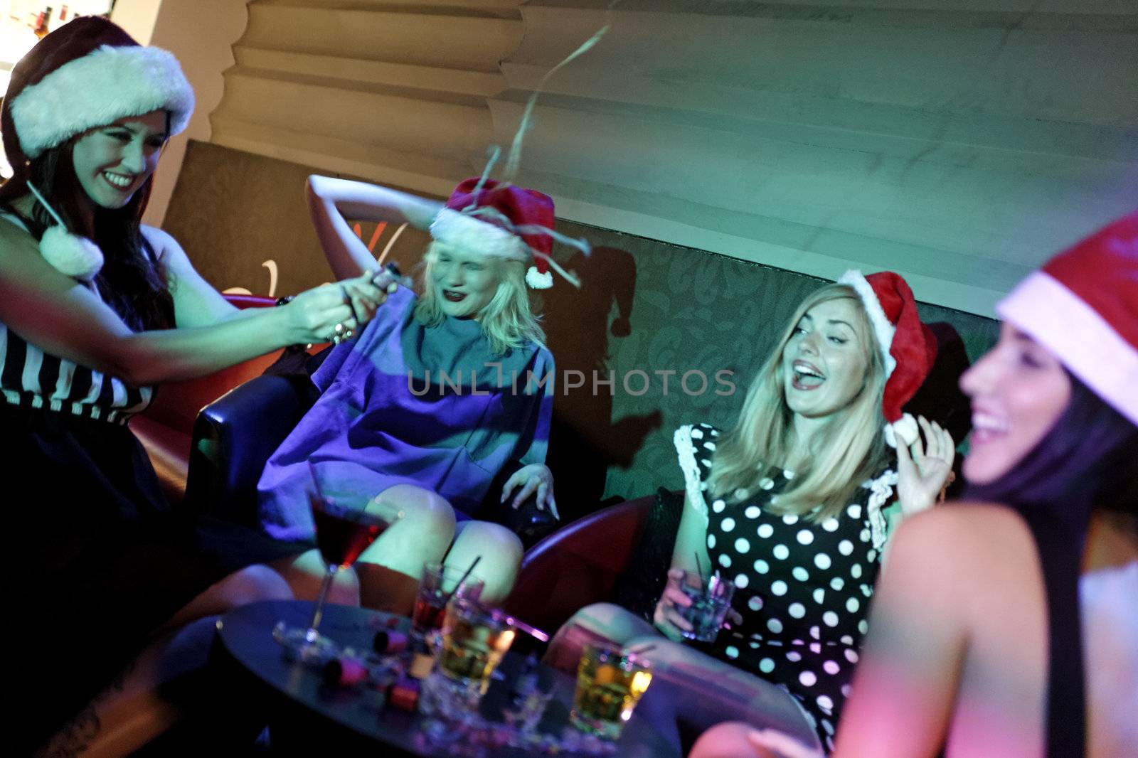 Attractive group of friends laughing and having fun at a Christmas party