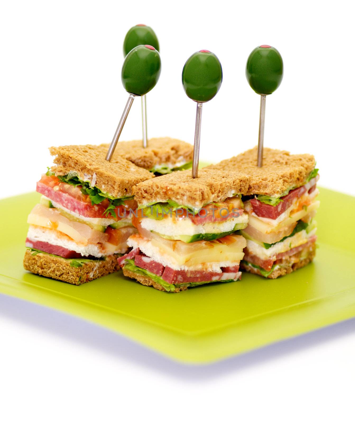Snacks of Classical BLT Club Sandwich isolated on green plate