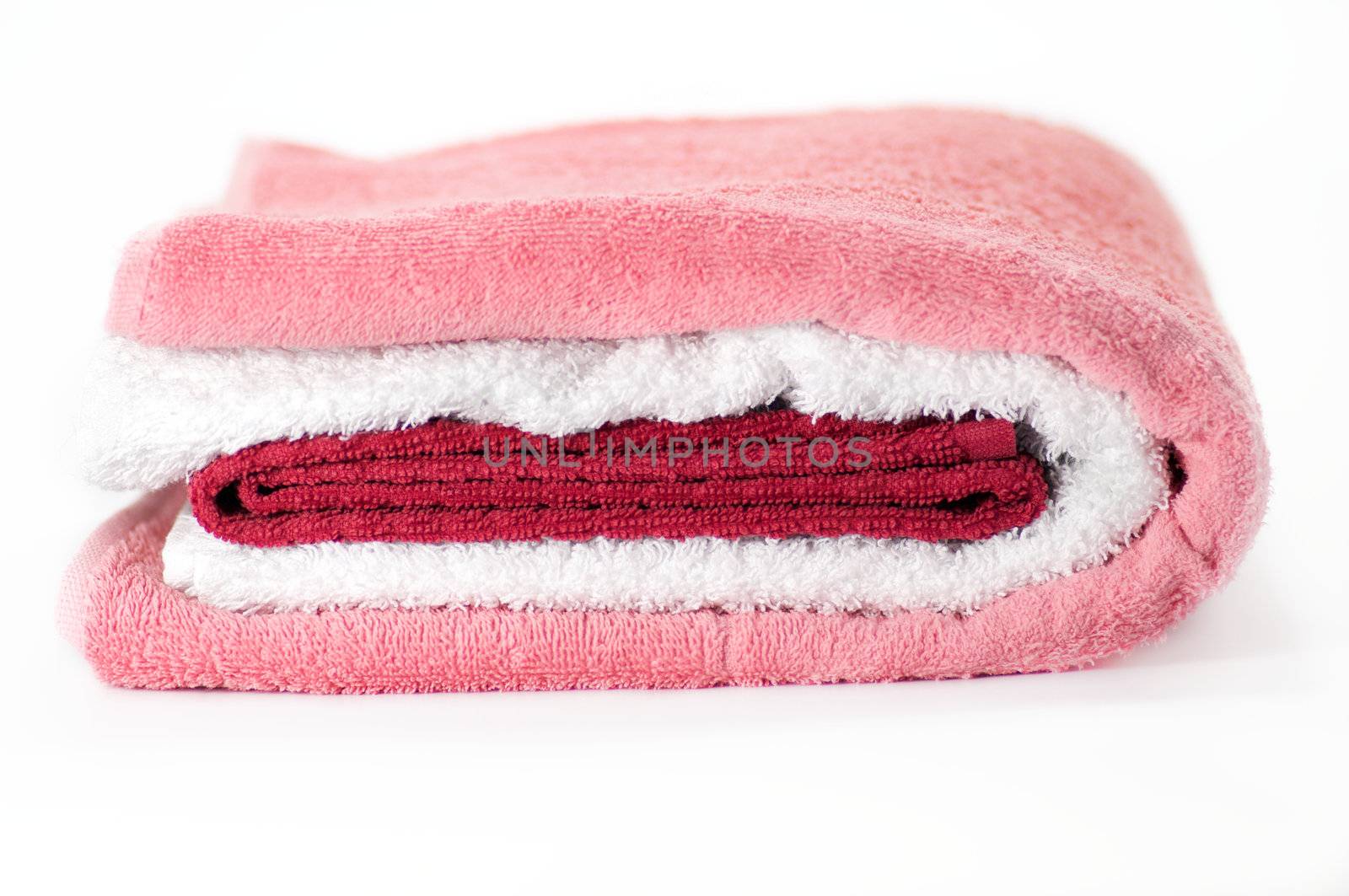 White, red and pink Terry towels isolated on white background