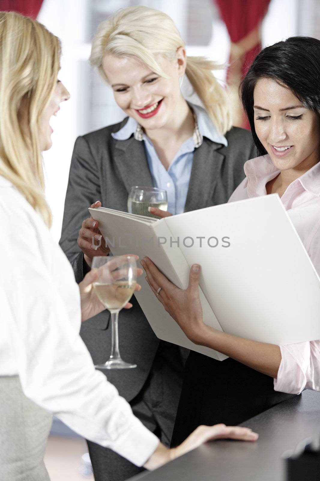 Three work colleagues reading menu by studiofi