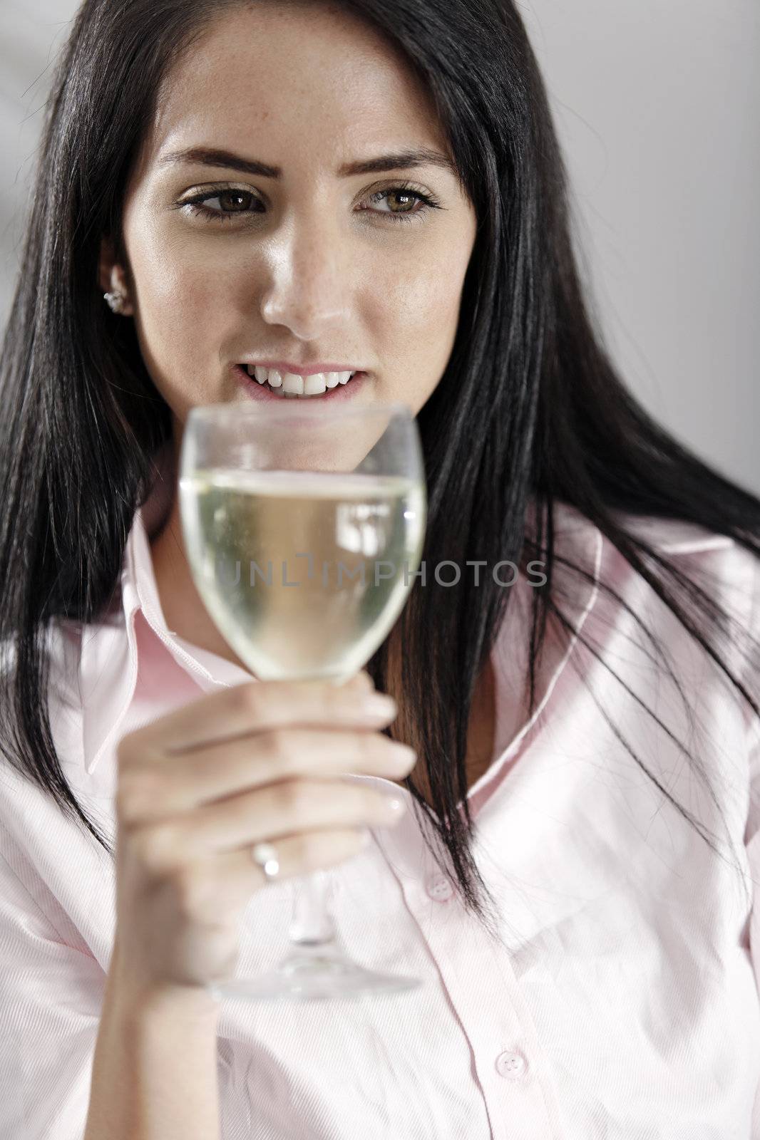 Young woman enjoying a glass of wine after work.