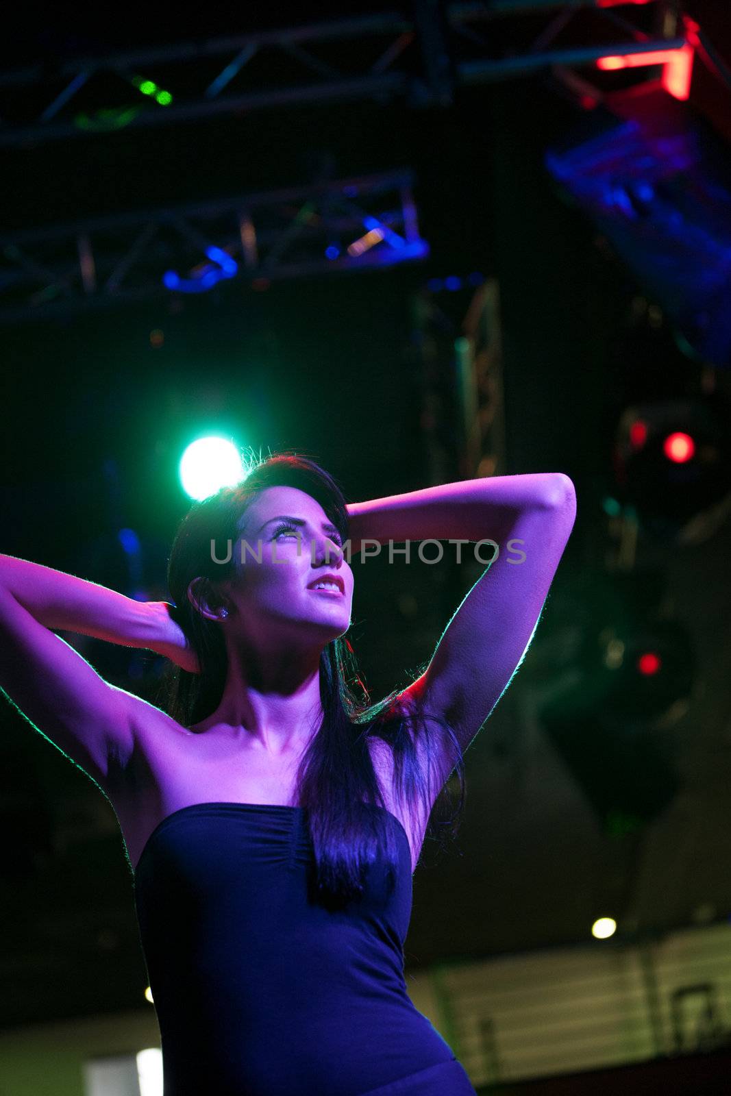 Attractive young woman dancing in a nightclub