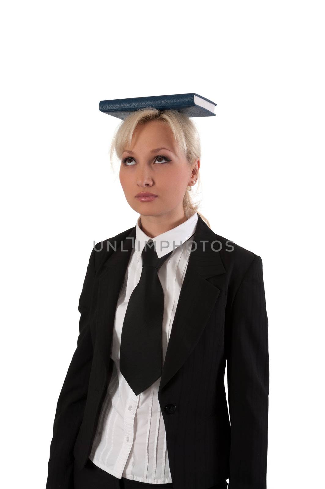 Blonde girl holds the book on a head is isolated on a white background.