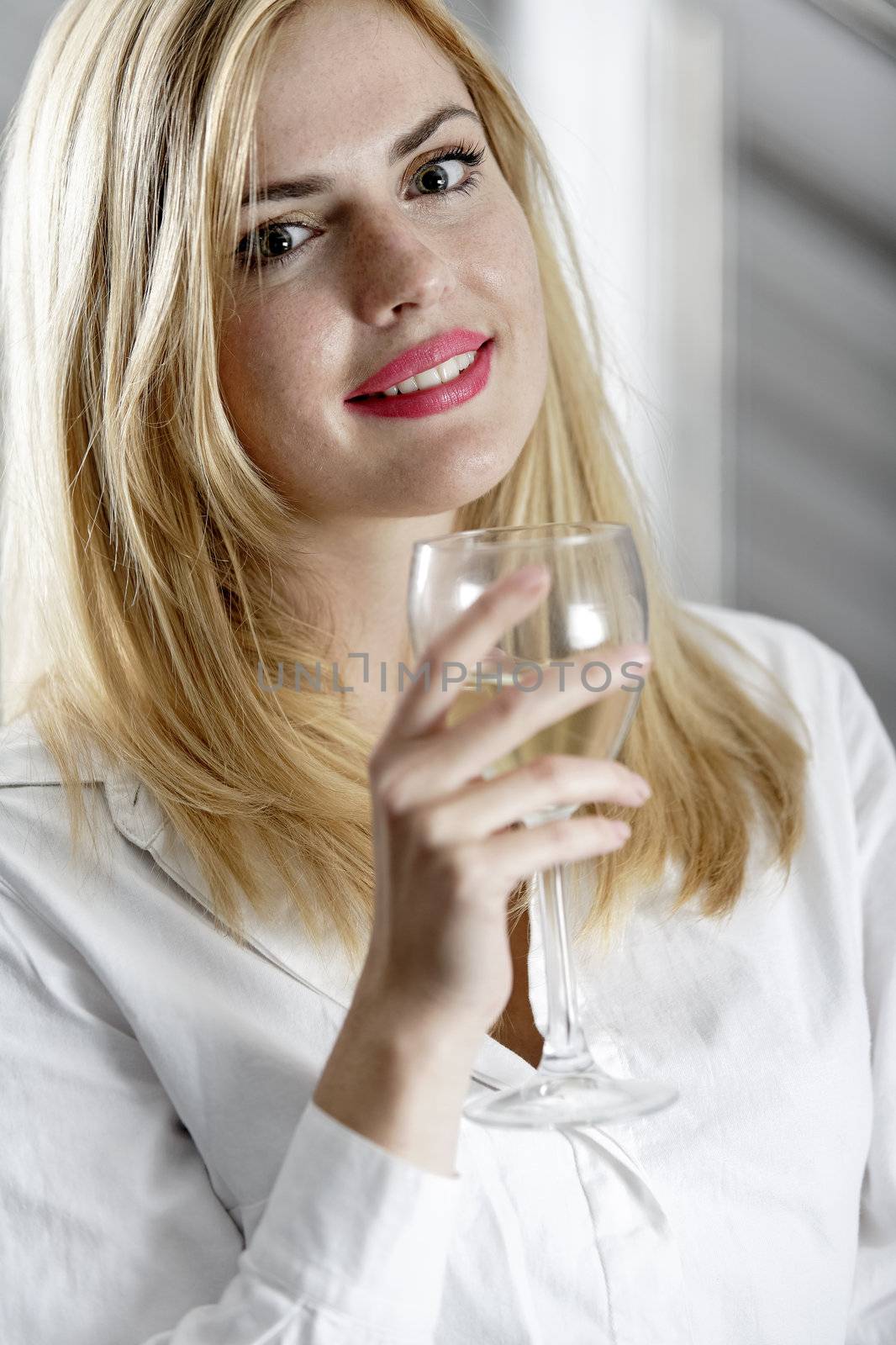 Young woman enjoying a glass of wine after work.
