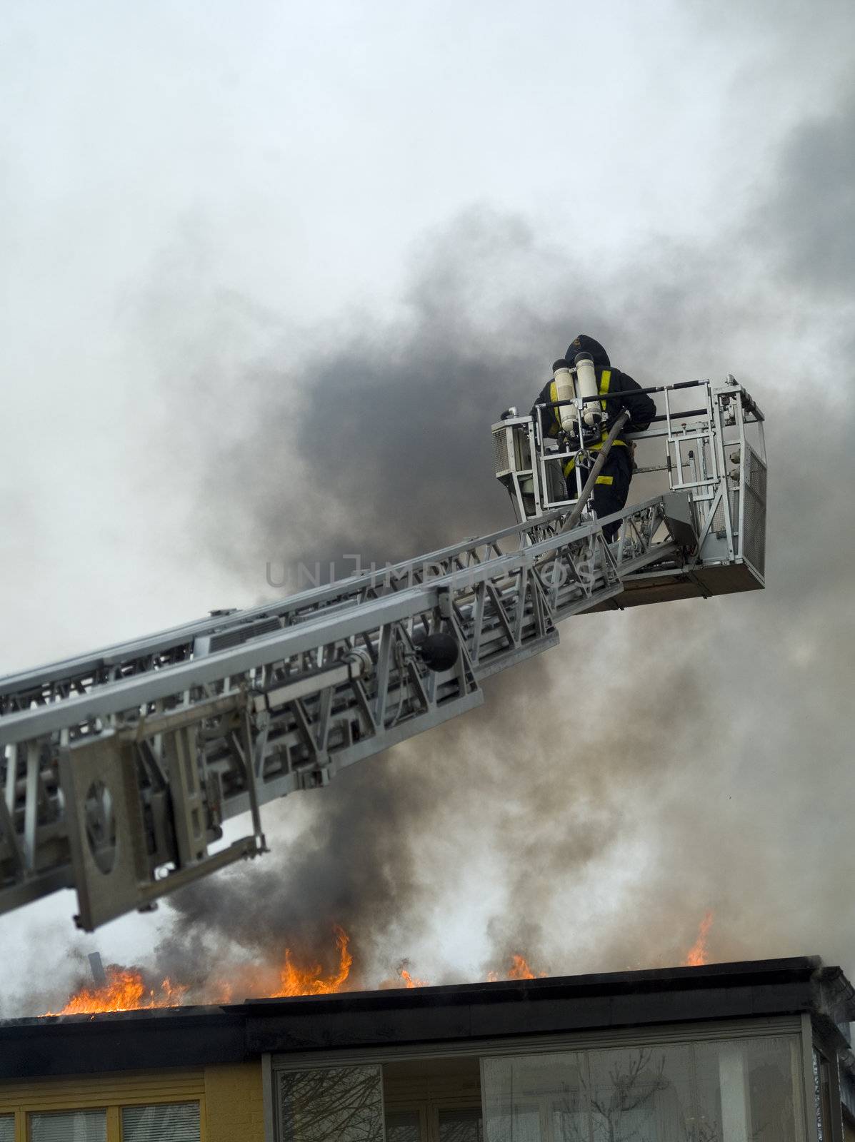 Fireman working on top of a ladder