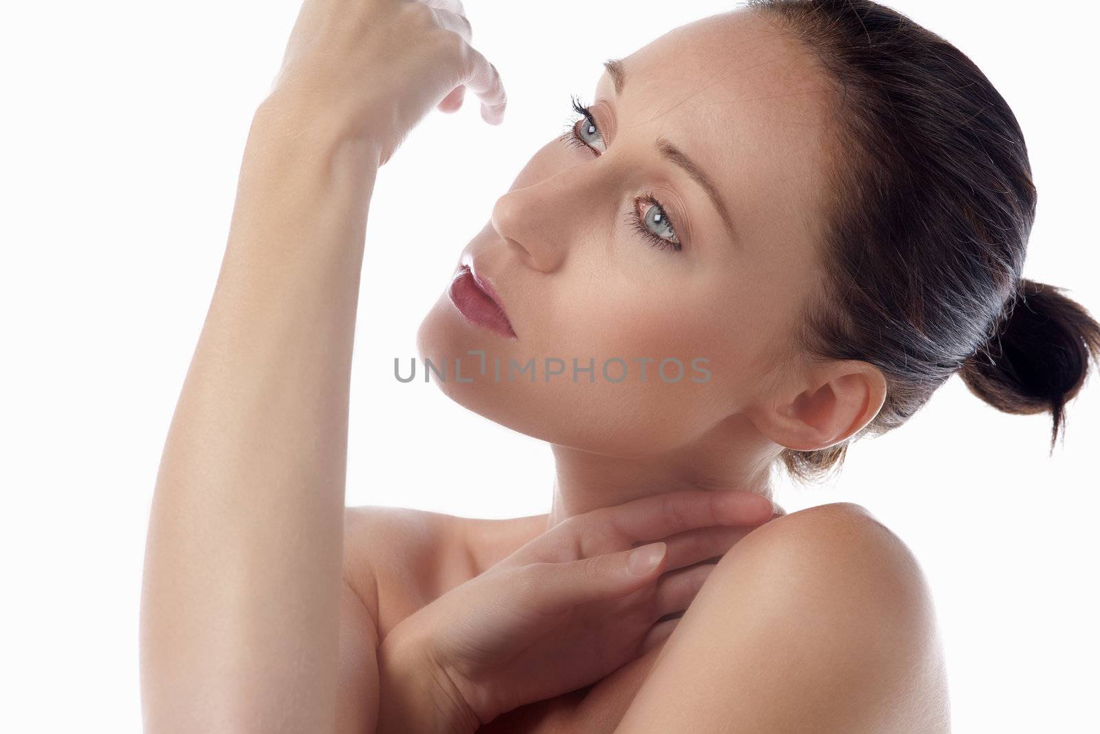 Female model looking at her hands in beauty style pose on white bakground