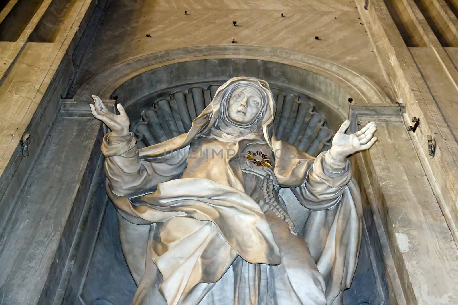 statue of a saint imploring, act of faith (Rome Italy)