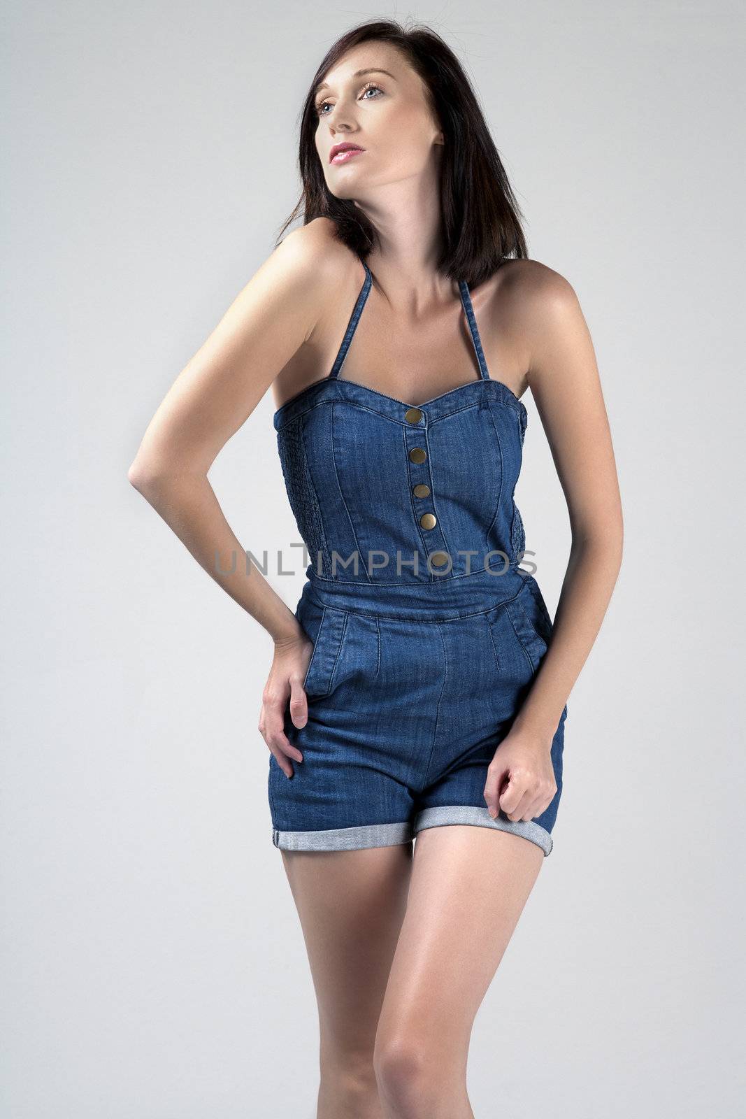 Female model wearing denim suit on isolated background