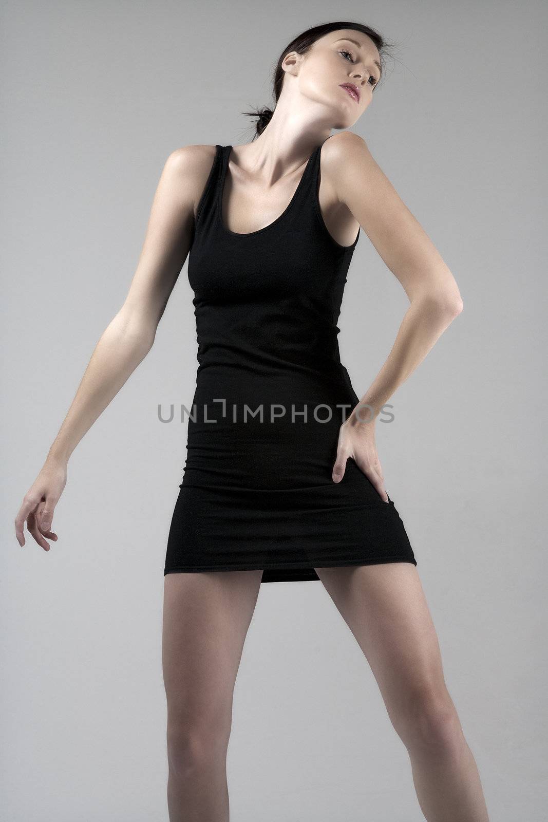 Woman wearing a little black dress on an isolated bakground