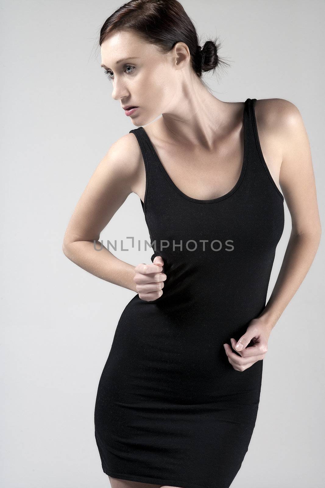 Woman wearing a little black dress on an isolated bakground