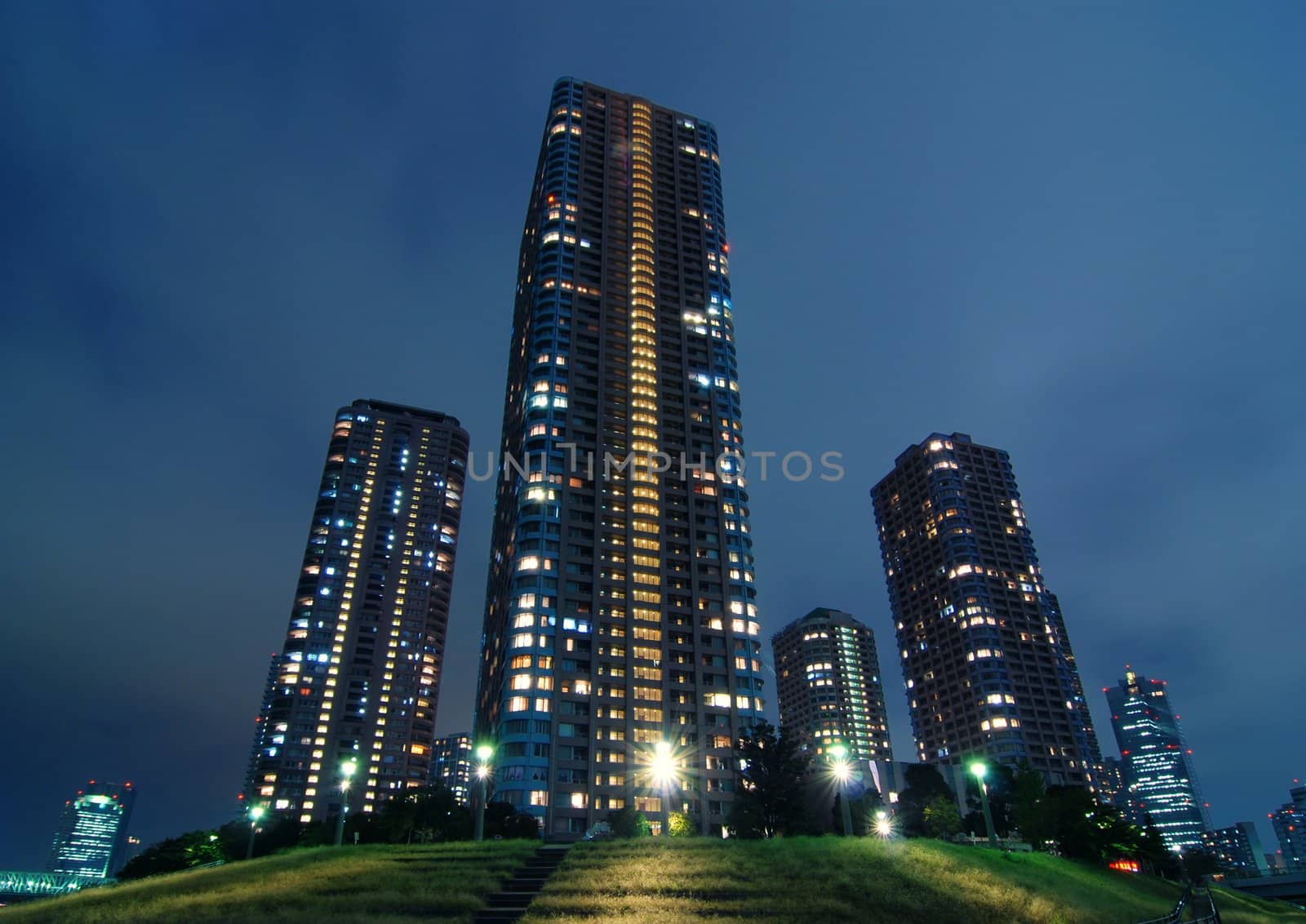 skyscraper buildings with night illumination inside modern Tokyo, Japan