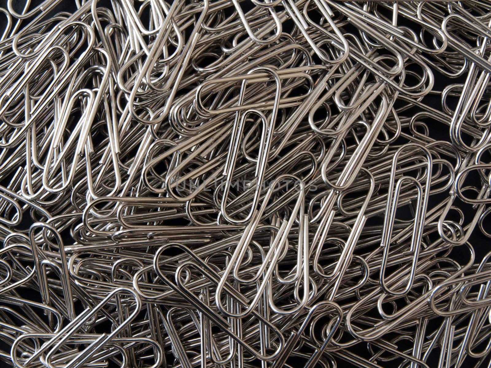 Close-up of lots of  silver paper clips .