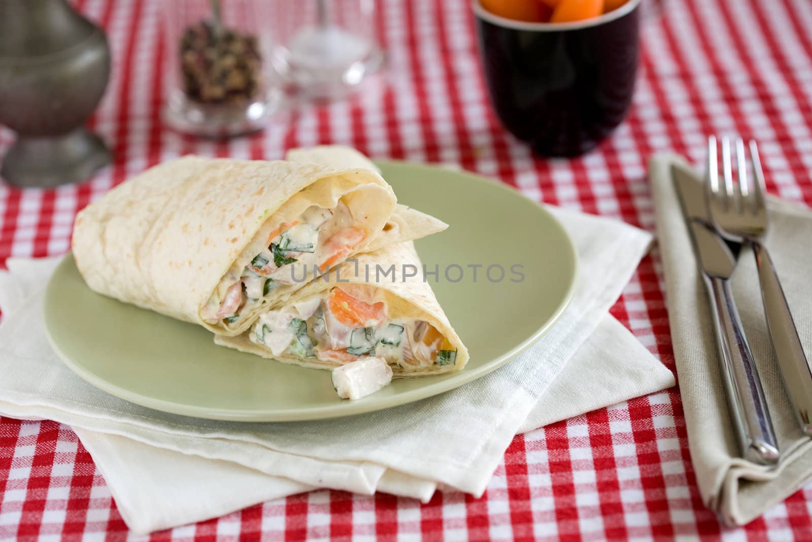 Two sliced mexican wraps filled with a salad of smoked chicken, onions, avocado and carrots