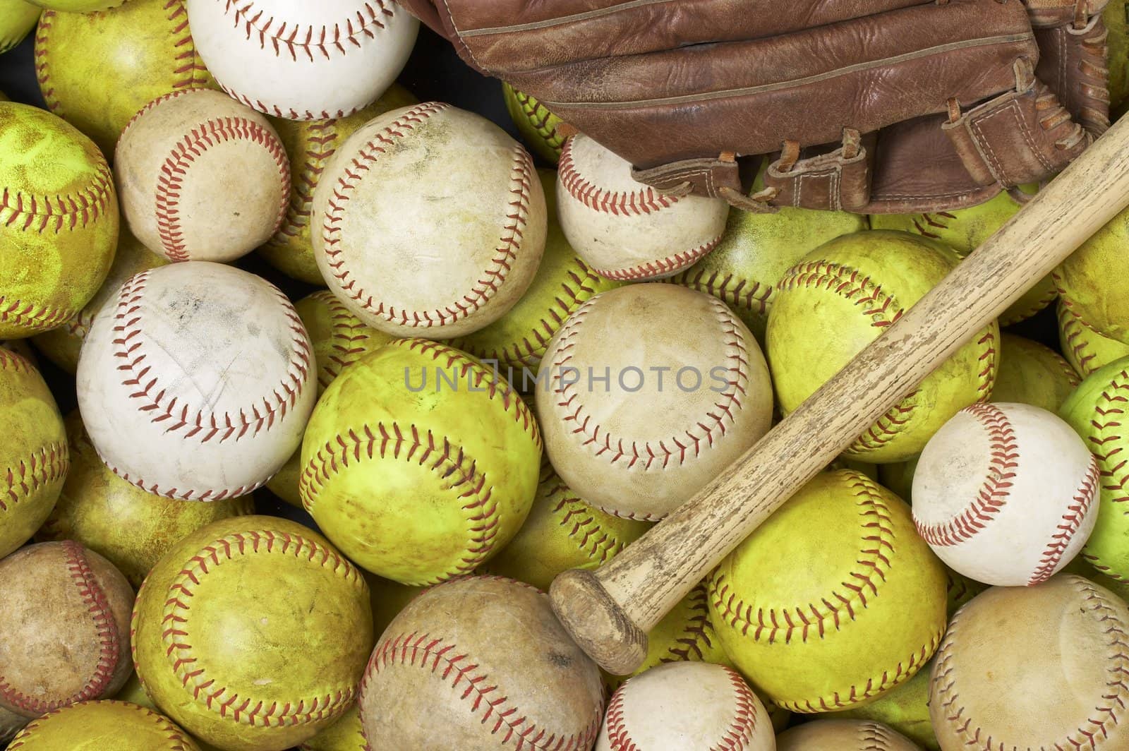 a picture of baseballs, softballs, a bat and glove