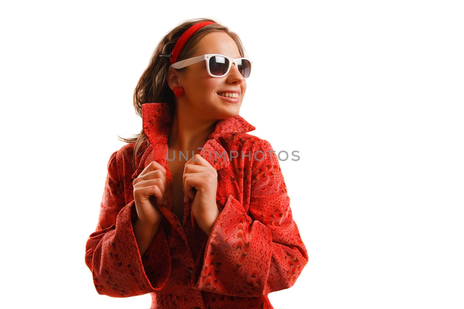 Modern looking young woman wearing a red jacket and sunglasses
