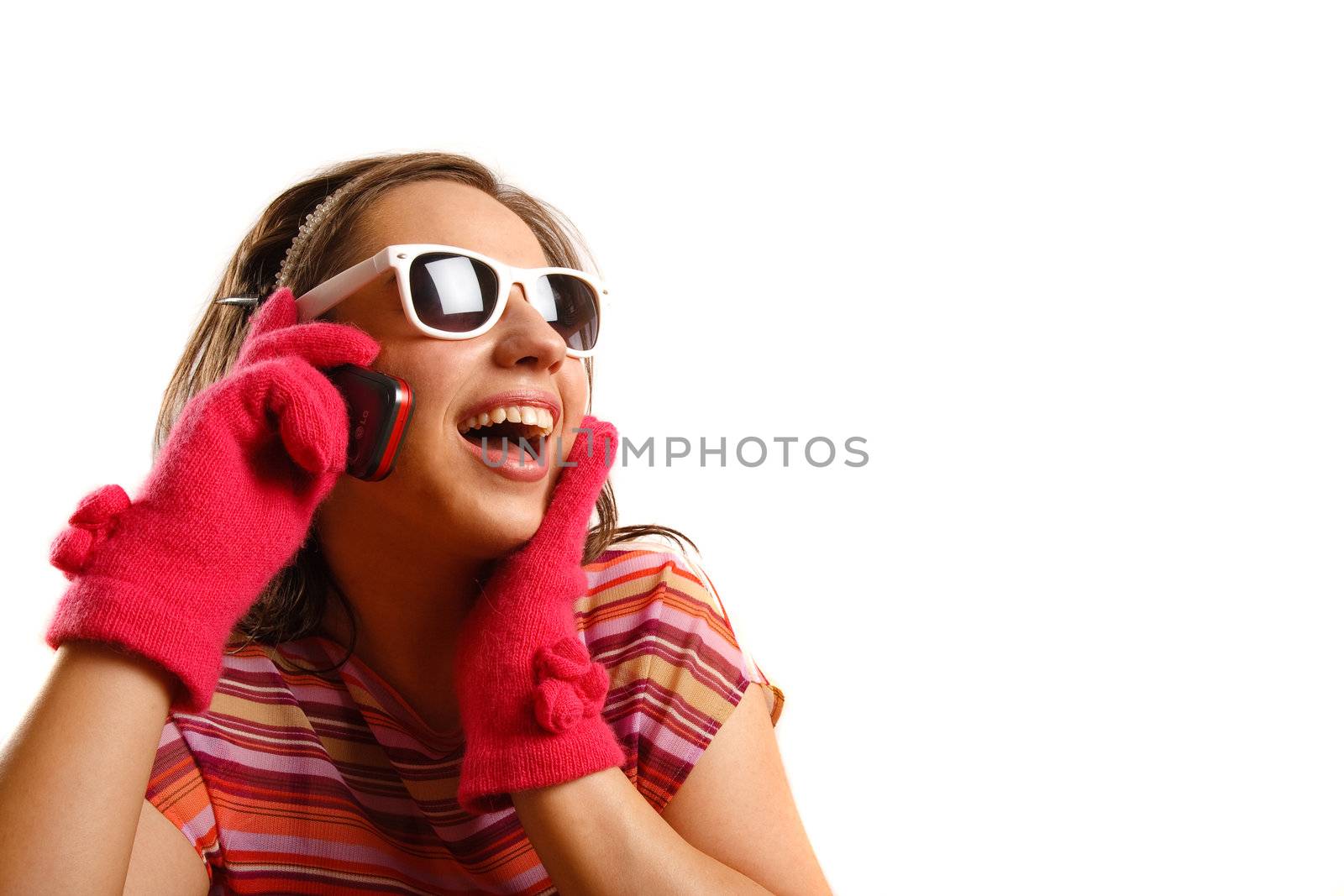 Modern looking young woman wearing sun glasses, talking on the phone