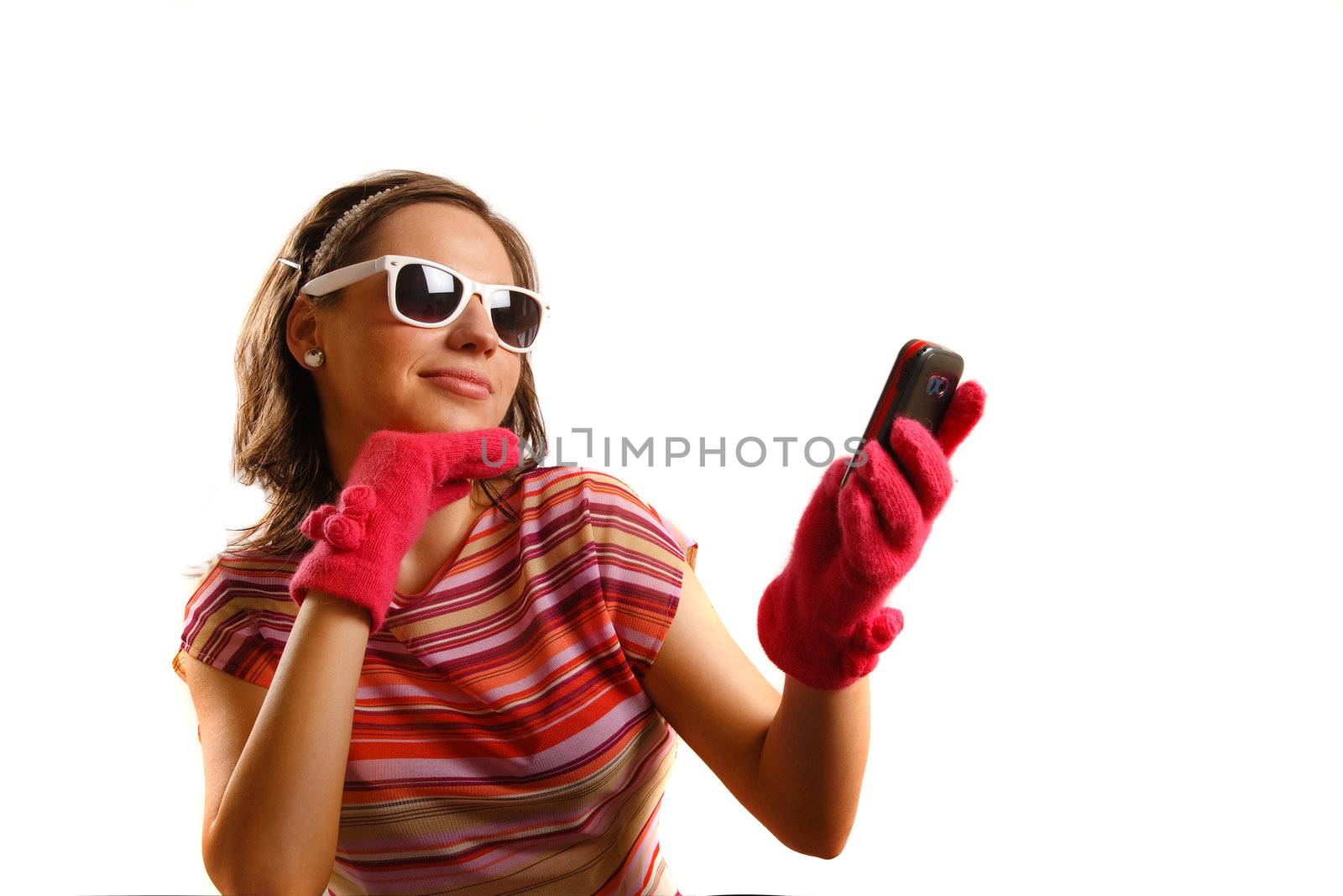 Modern looking young woman wearing sun glasses, looking at the phone