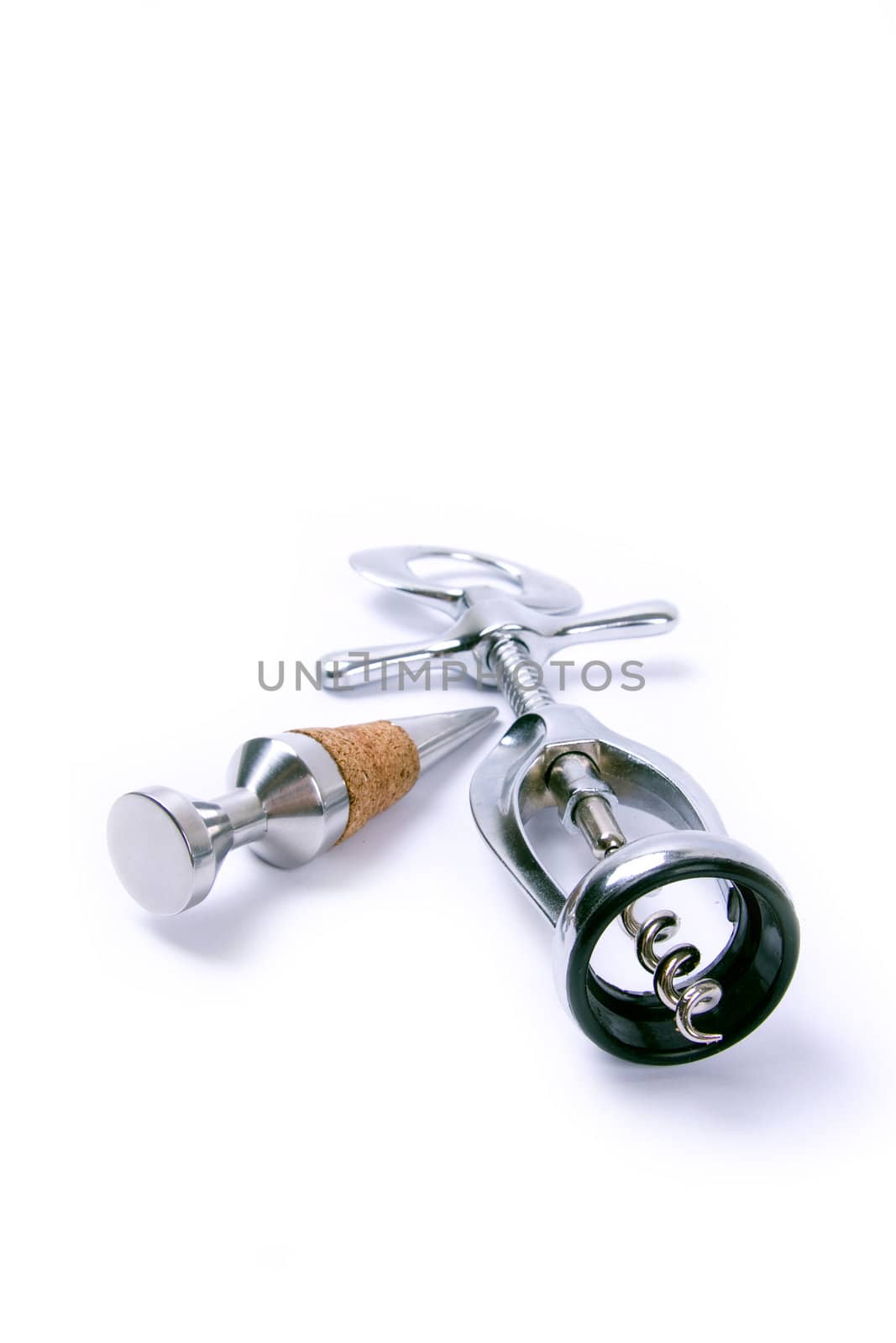 Silver corkscrew and metal cork on white background.