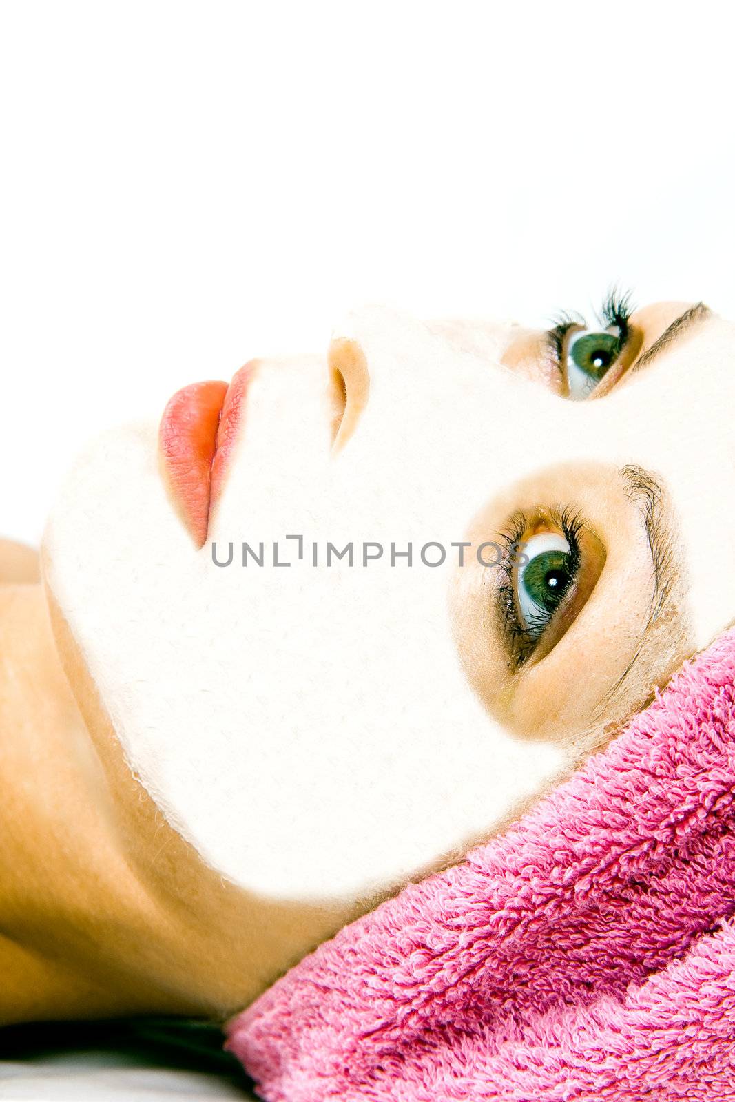 Beautiful woman during the spa treatment isolated on white.