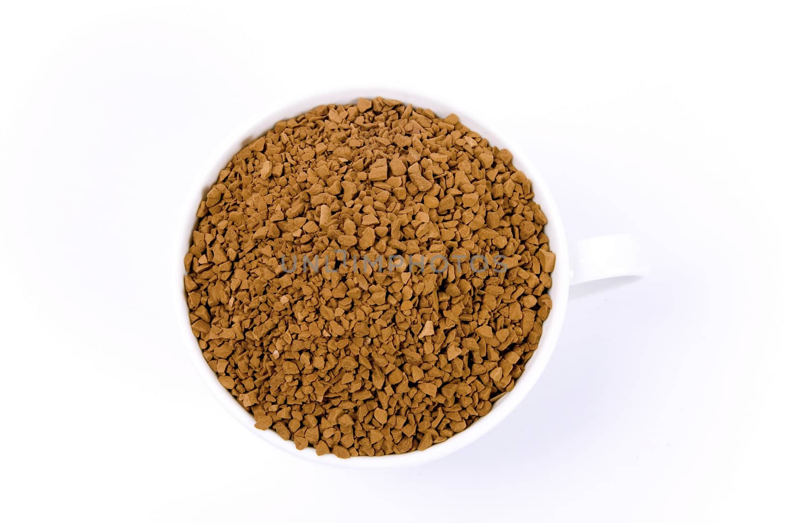 Coffee granules in a white cup isolated.