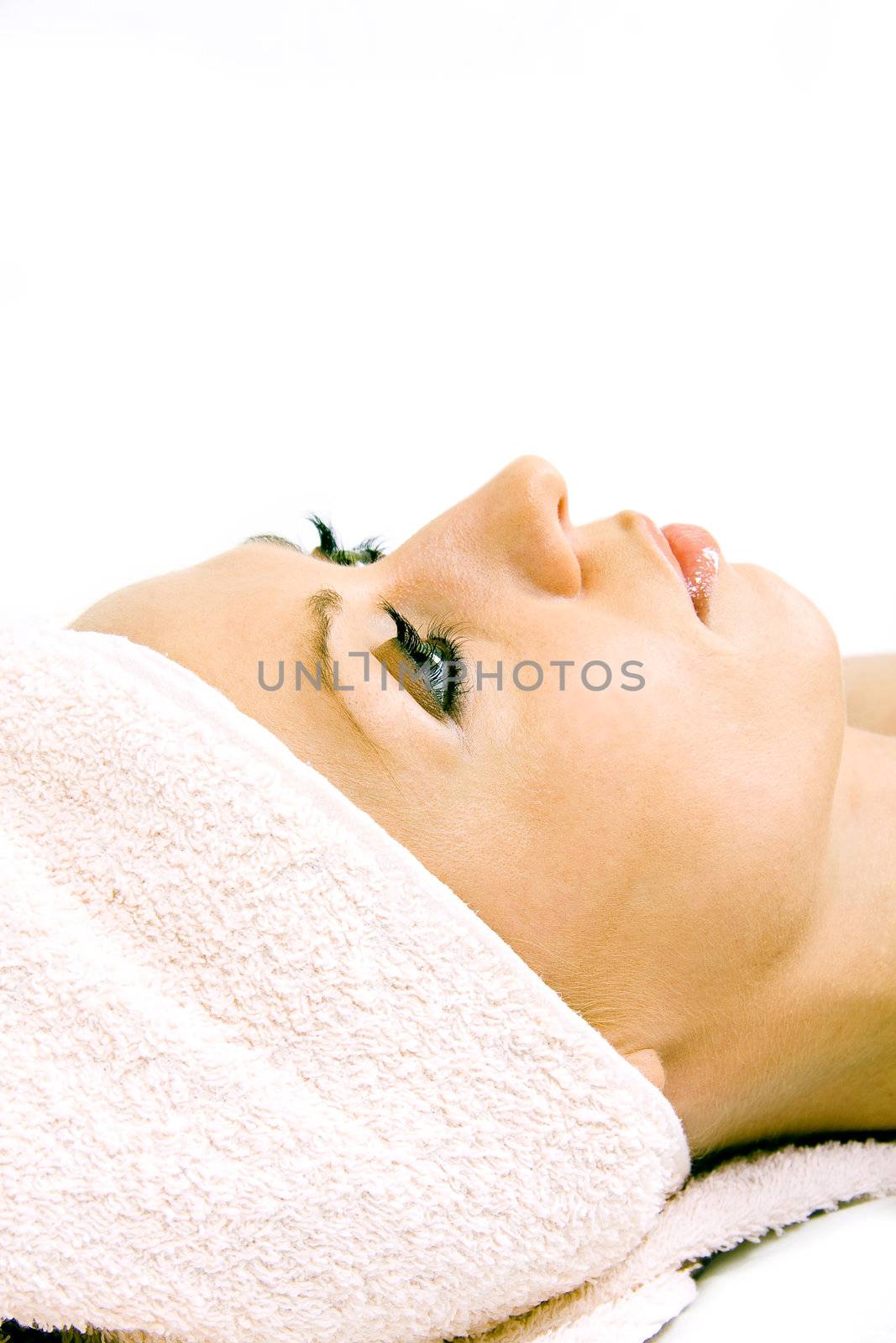 Beautiful woman during the spa treatment isolated on white.