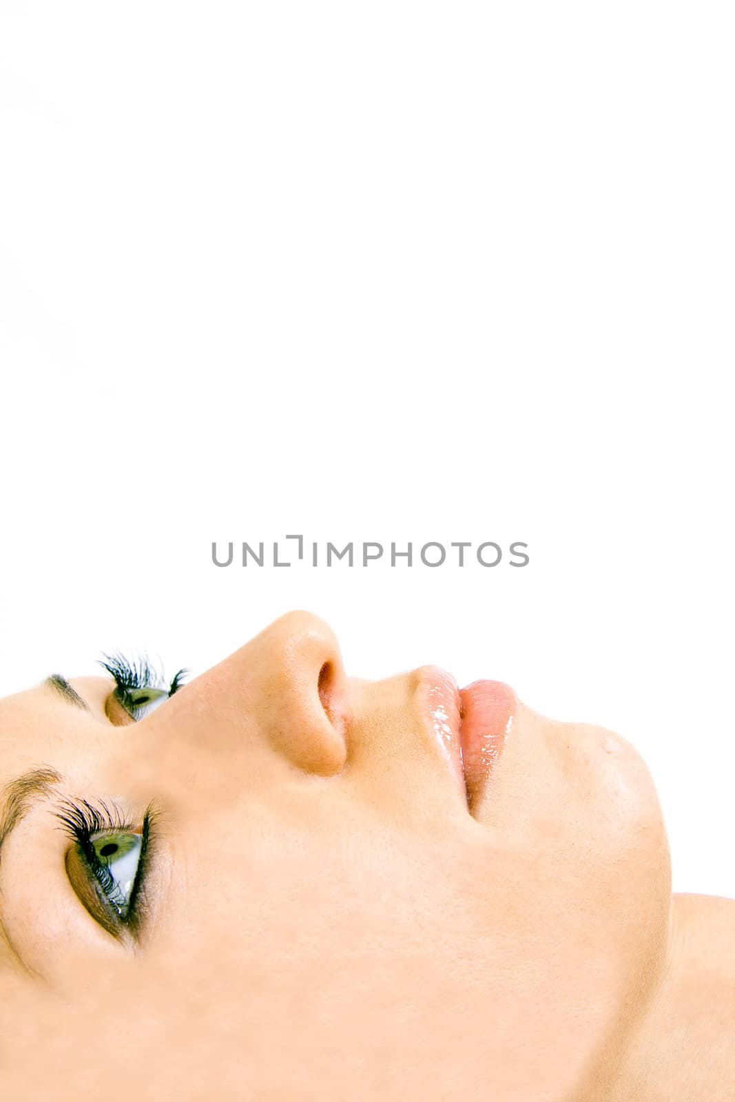 Close-up of beautiful woman face with green eyes. On white background