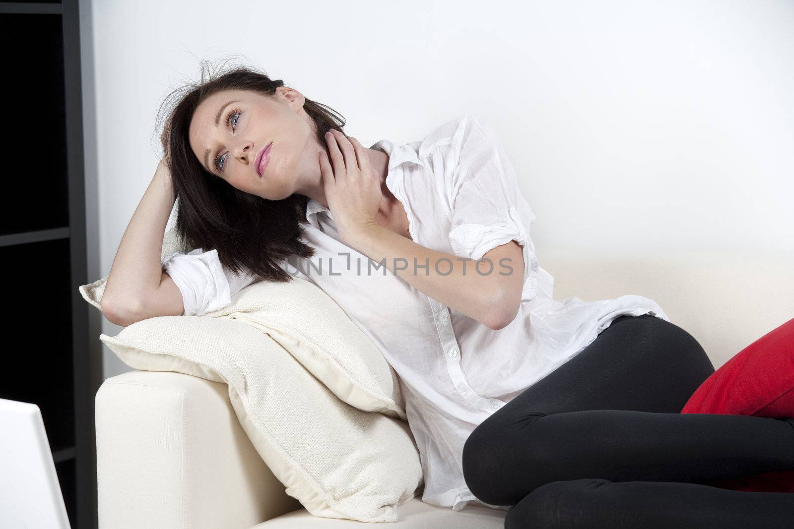 Woman resting on sofa at home in casual wear