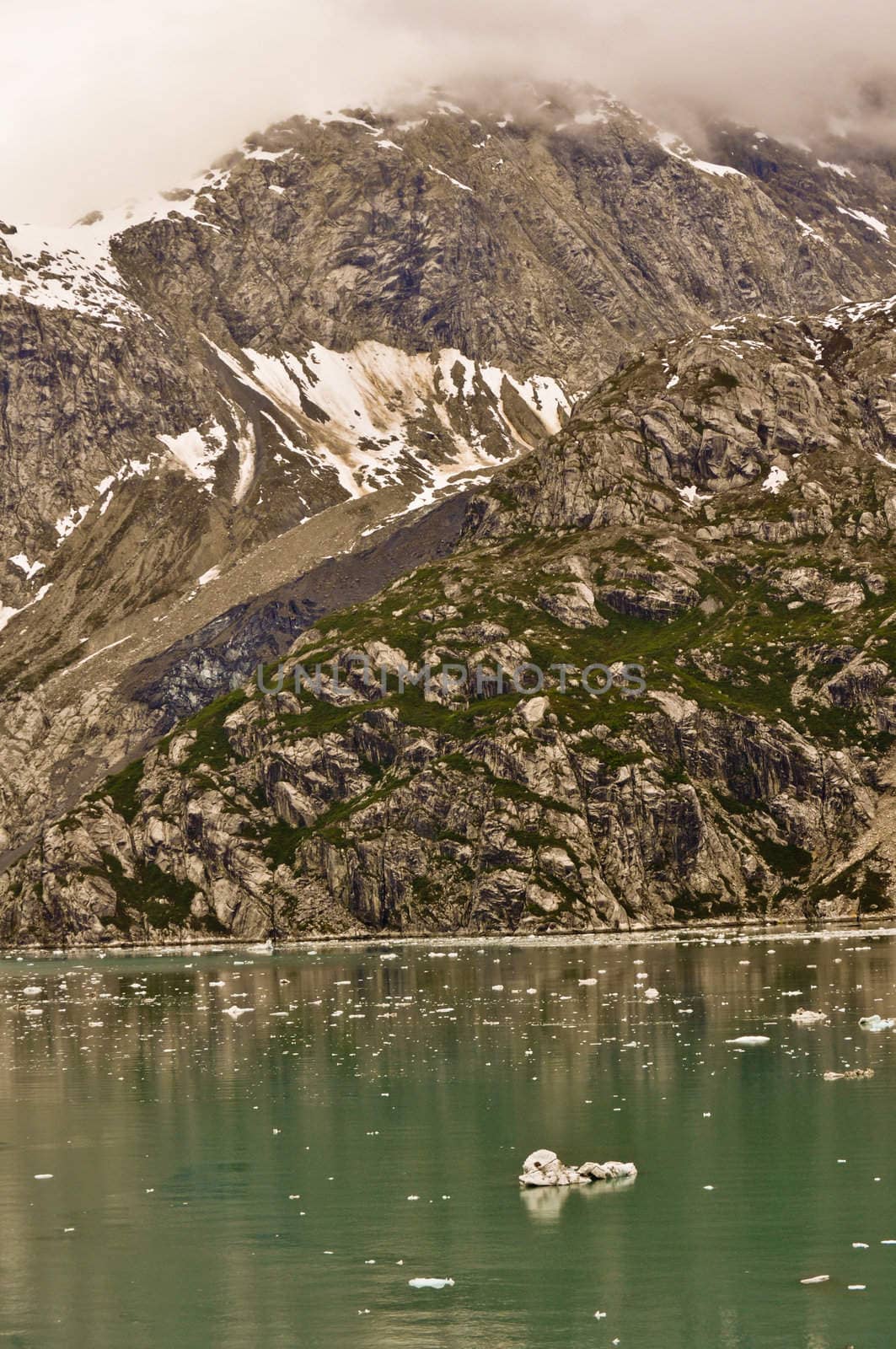 Alaskan Glacier with iceberg in water by RefocusPhoto