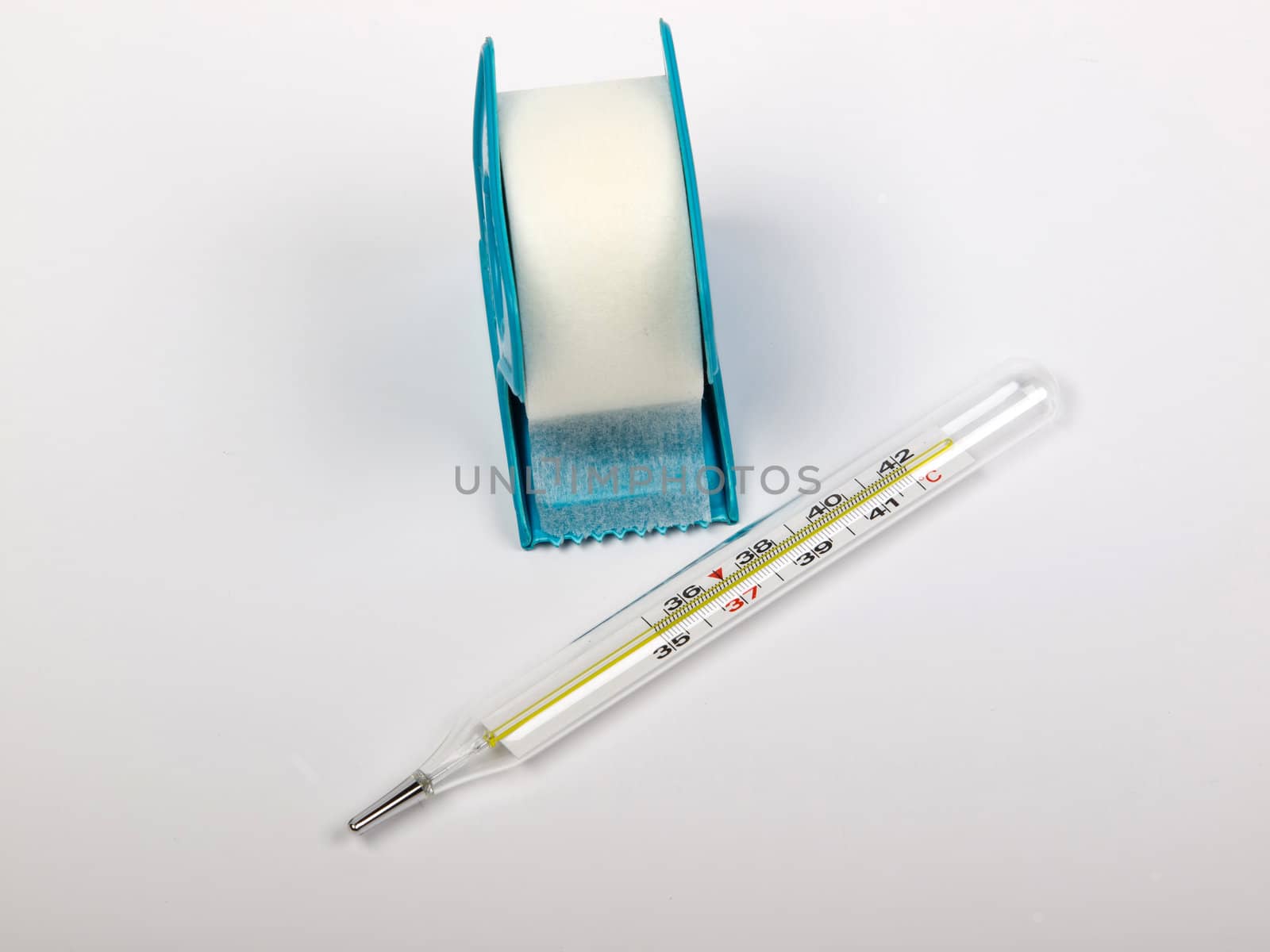 thermometer and the white adhesive bandage