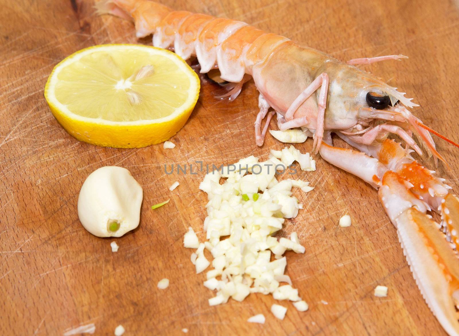 shrimp with lemon and garlic on  wooden cooking plate