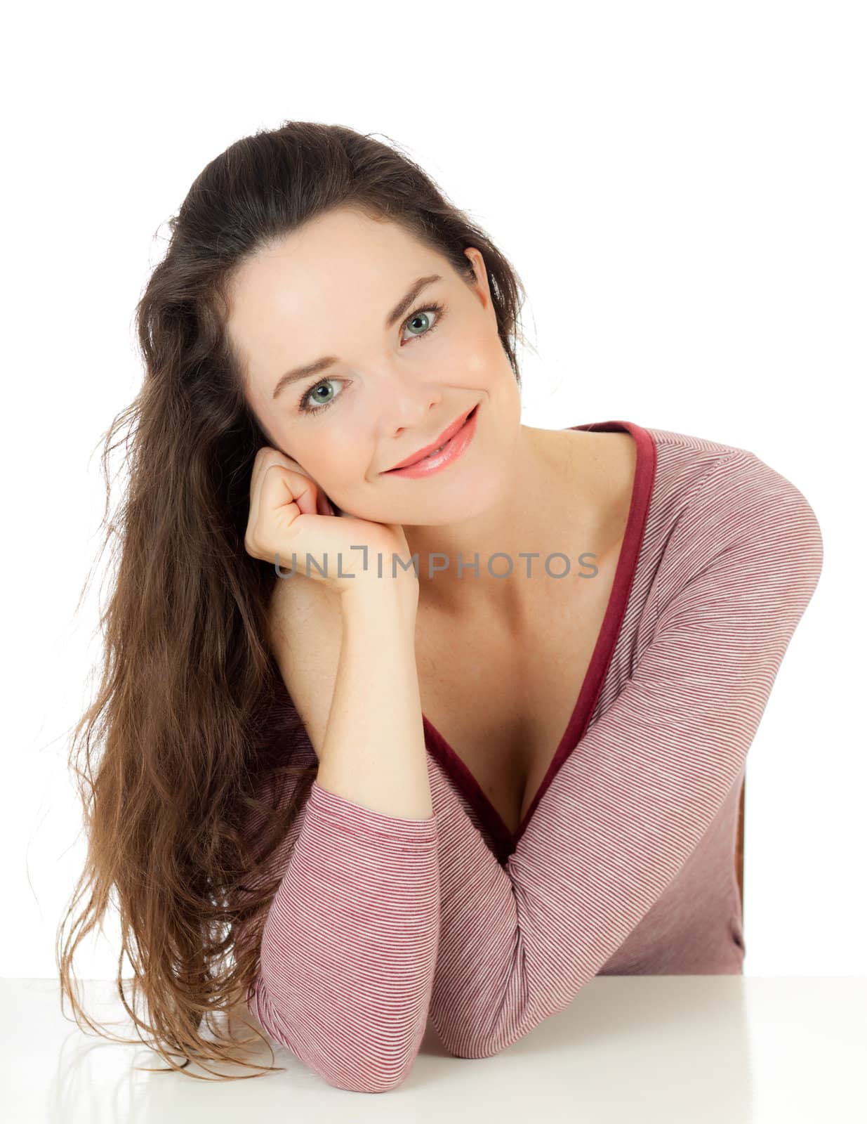 Isolated portrait of an attractive young female sitting down relaxing.