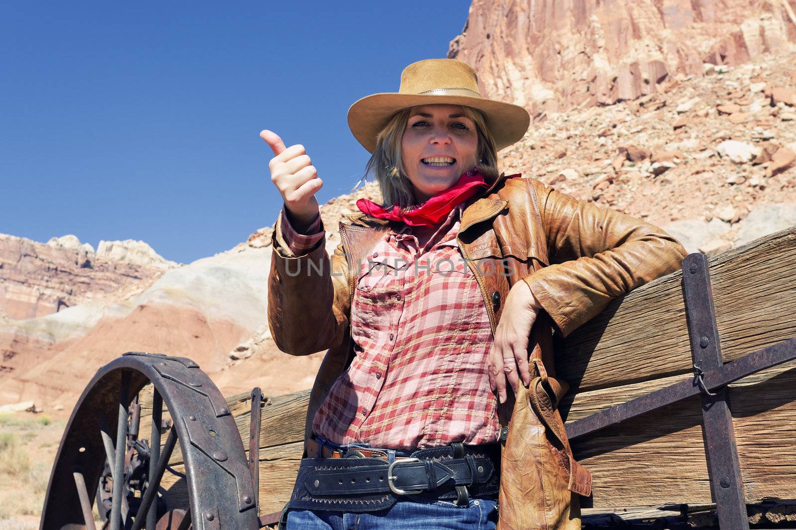 portrait of happy blond young woman wearing a cowboy hat