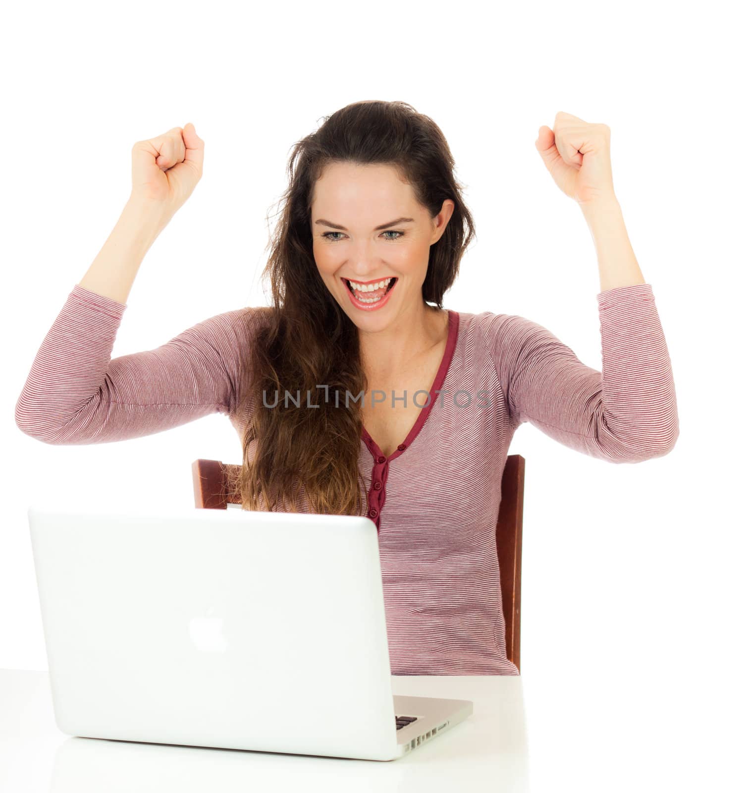 Closeup portrait of a very happy beautiful female looking at laptop and laughing.