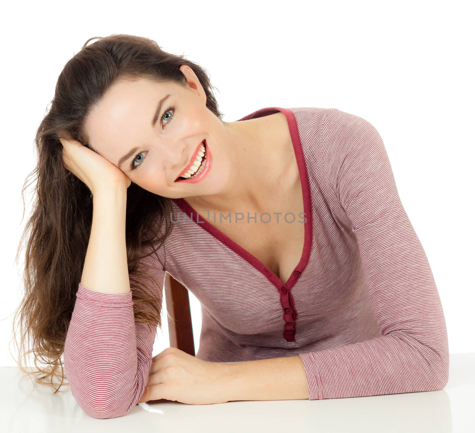 A gorgeous happy healthy young woman relaxing and smiles at camera. Isolated over white.